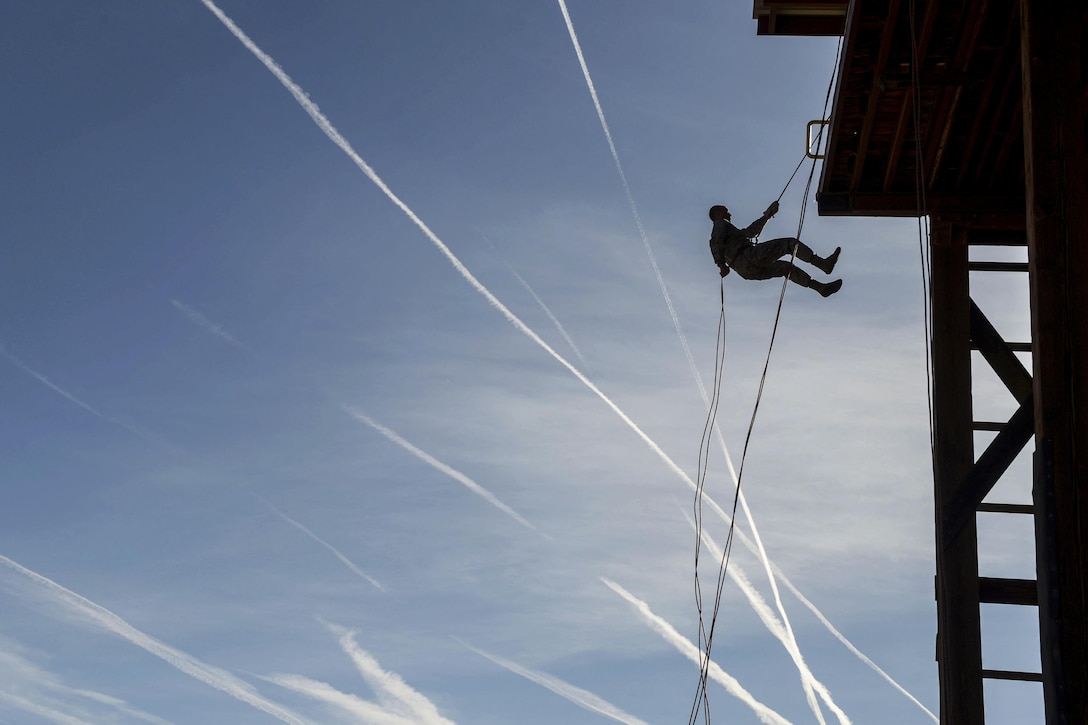 An airman rappels off a tower during Operational Contract Support Joint Exercise 2016 at Fort Bliss, Texas, March 22, 2016. Air Force photo by Staff Sgt. Jonathan Snyder