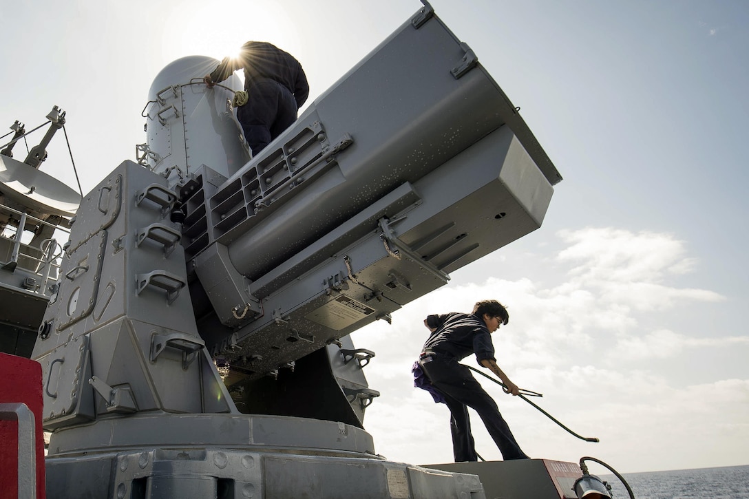 Navy Petty Officers 2nd Class Joseph Comparato, top, and Jocelyn Caro clean and maintain a close-in weapon system aboard the USS Porter in the Mediterranean Sea, March 26, 2016. The Porter is conducting a routine patrol in the U.S. 6th Fleet area of responsibility to support U.S. national security interests in Europe. Navy photo by Petty Officer 3rd Class Robert S. Price