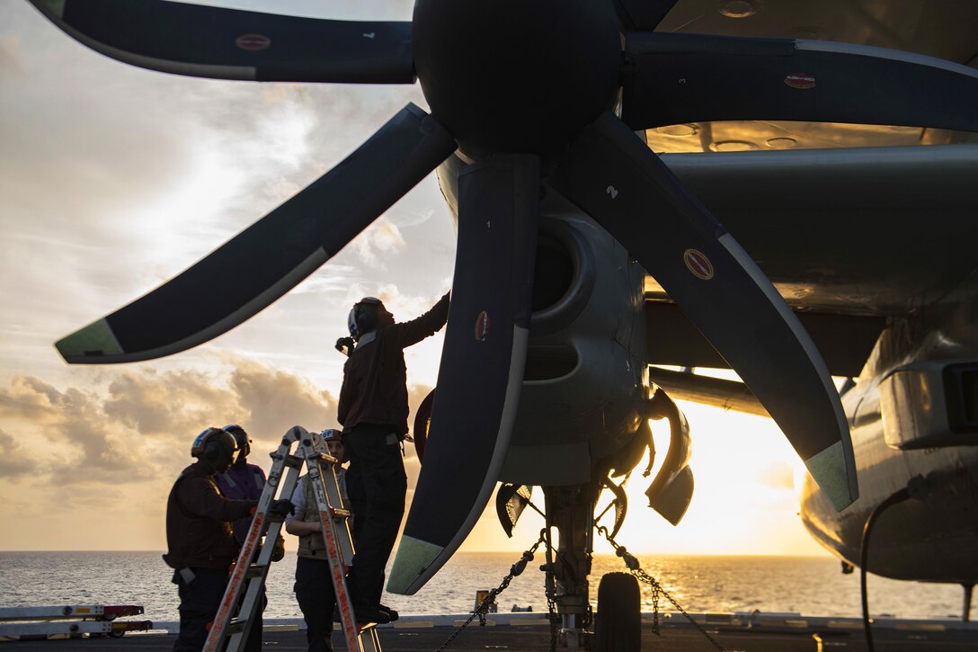 Sailors conduct maintenance on an E-2C Hawkeye on the flight deck of the aircraft carrier USS Dwight D. Eisenhower in the Atlantic Ocean, March 24, 2016. The Eisenhower is conducting training in preparation for a deployment. Navy photo by Seaman Nathan Bear