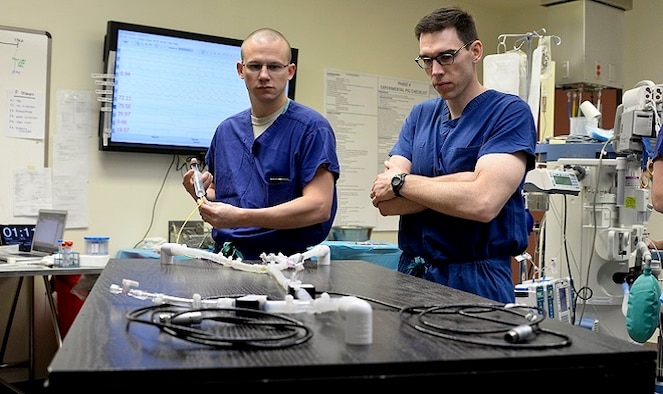 Majs. Timothy Williams and Lucas Neff perform bench top testing of balloon catheters at Travis Air Force Base, Calif., using a custom-made blood flow simulator. The Clinical Investigation Facility, located at David Grant U.S. Air Force Medical Center, is the research facility where the REBOA catheter came to fruition. (U.S. Air Force photo/Senior Airman Amber Carter)