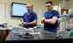 Majs. Timothy Williams and Lucas Neff perform bench top testing of balloon catheters at Travis Air Force Base, Calif., using a custom-made blood flow simulator. The Clinical Investigation Facility, located at David Grant U.S. Air Force Medical Center, is the research facility where the REBOA catheter came to fruition. (U.S. Air Force photo/Senior Airman Amber Carter)