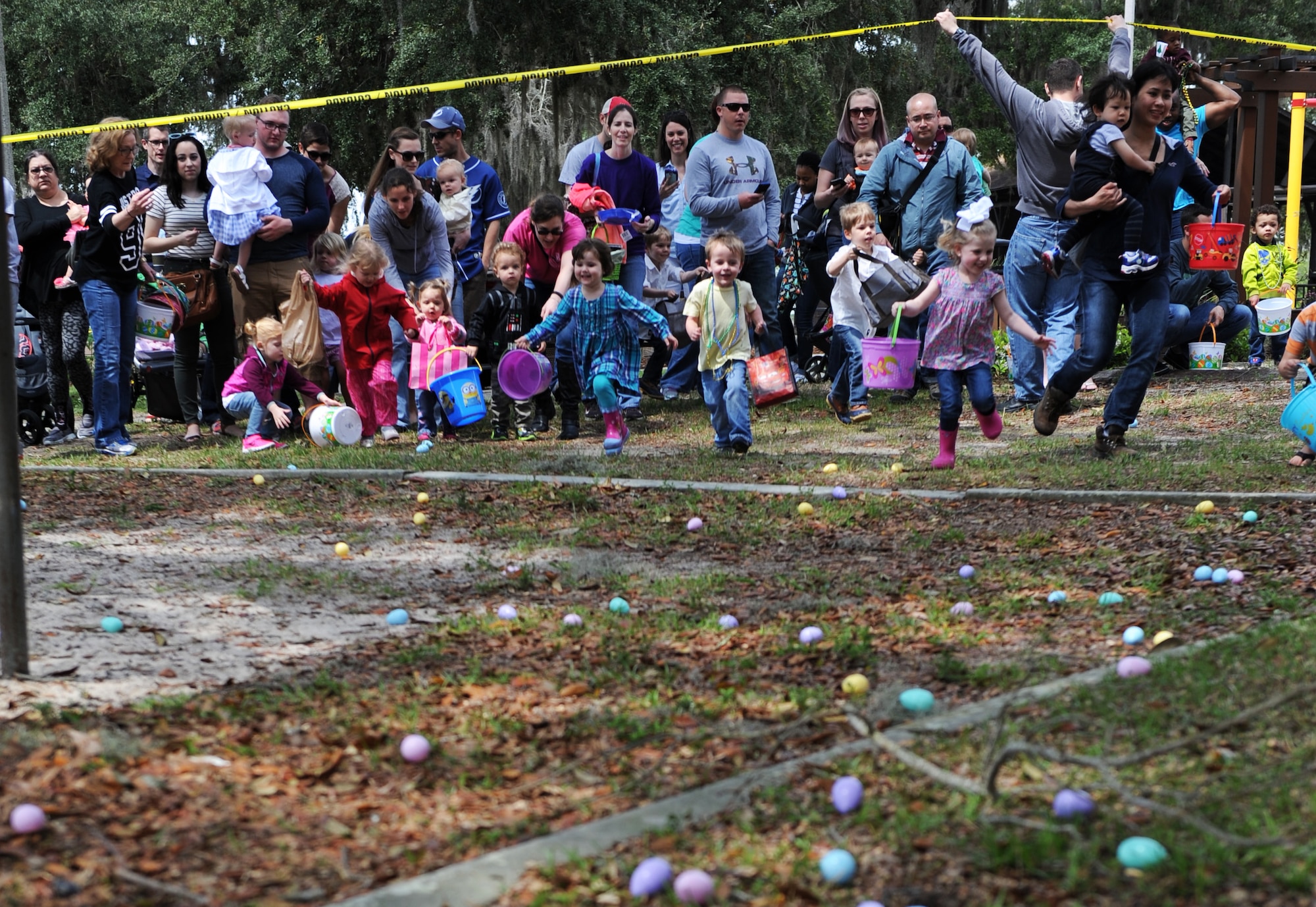 Children participate in an Easter egg hunt during Easter in the Park at the marina Mar. 26, 2016, Keesler Air Force Base, Miss. The event also included a youth fun run, arts and crafts, games and visits with the Easter Bunny. (U.S. Air Force photo by Kemberly Groue)