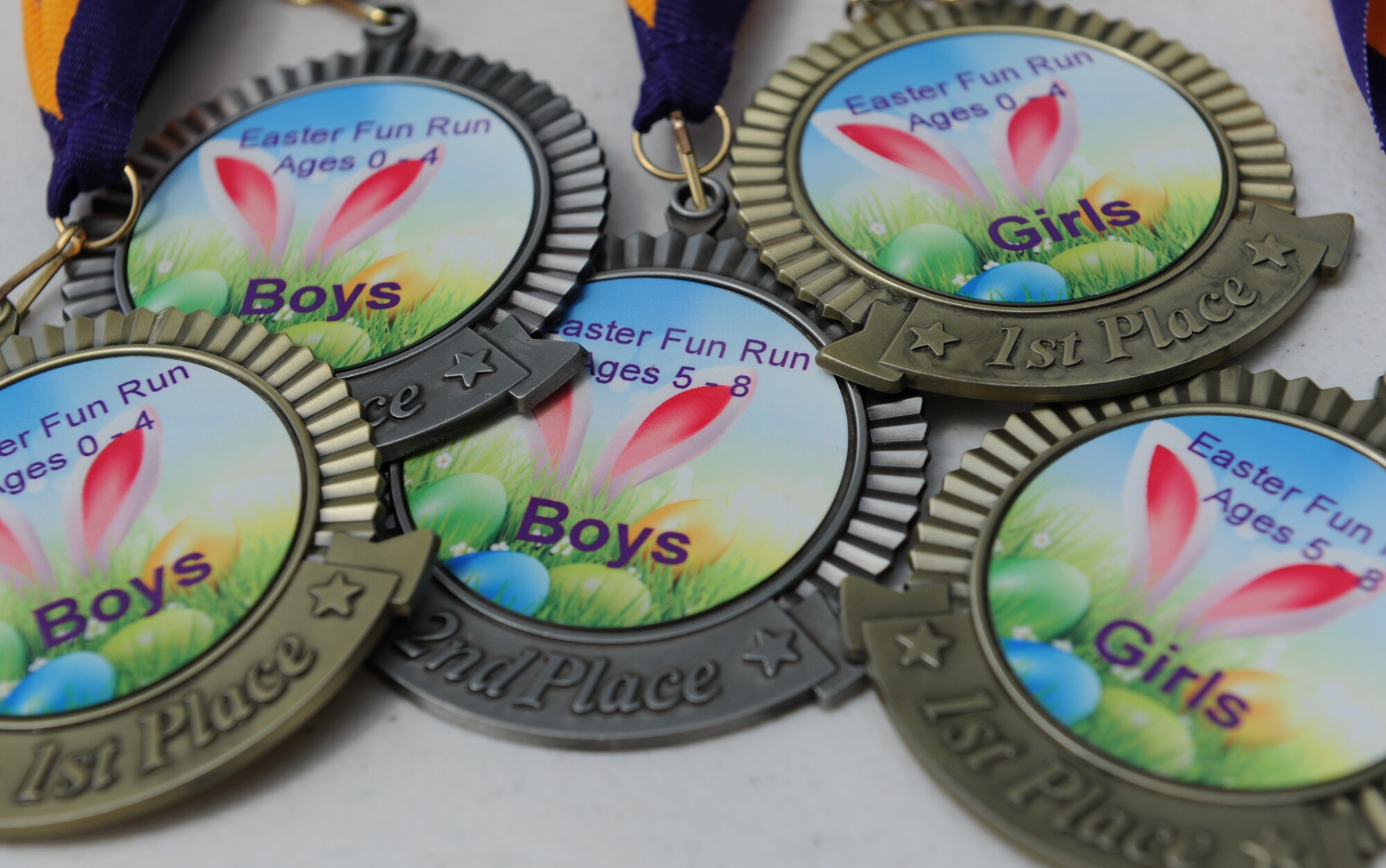 Youth Fun Run medals sit on display during Easter in the Park at the marina Mar. 26, 2016, Keesler Air Force Base, Miss. Easter in the Park also included an egg hunt, arts and crafts, games and visits with the Easter Bunny. (U.S. Air Force photo by Kemberly Groue)