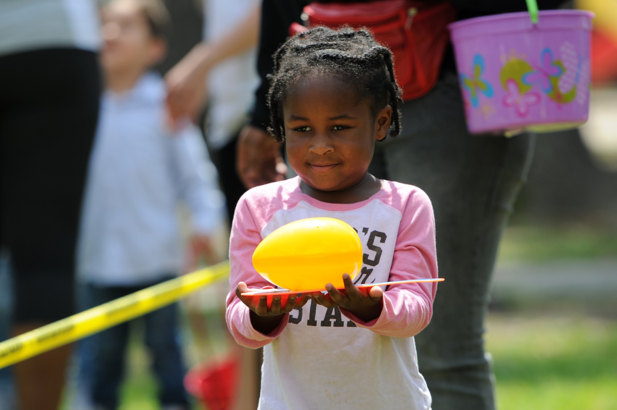 Lovely Arnold, daughter of Staff Sgt. Duron Arnold, 81st Security Forces Squadron unit deployment manager, participates in a balancing egg game during Easter in the Park at the marina Mar. 26, 2016, Keesler Air Force Base, Miss. The event also included an egg hunt, a youth fun run, arts and crafts and visits with the Easter Bunny. (U.S. Air Force photo by Kemberly Groue)