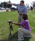 DAHLGREN, Va. (March 23, 2016) - Naval Surface Warfare Center Dahlgren Division (NSWCDD) systems engineer Deztany Jackson and NSWCDD scientist Timothy Leancu, a former Marine captain, use the fielded  Common Laser Range Finder (CLRF) and the Defense Advanced GPS Receiver to take targeting measurements. The CLRF is a lightweight, eye-safe laser rangefinder capable of being carried and employed by a single Marine.  It's primary functions are to assist the operator in target acquisition by measuring distance, direction, azimuth and vertical angle from the operator to an object.  The CLRF interfaces with the Defense Advanced GPS Receiver, which is a handheld GPS receiver providing an operator with real-time position measurements. Jackson was honored as a 2016 Black Engineer of the Year (BEYA) Modern-Day Technology Leader during BEYA's 30th annual Science, Technology, Engineering and Mathematics (STEM) Global Competitiveness Conference Awards Gala held in Philadelphia, Feb. 18-20. 
