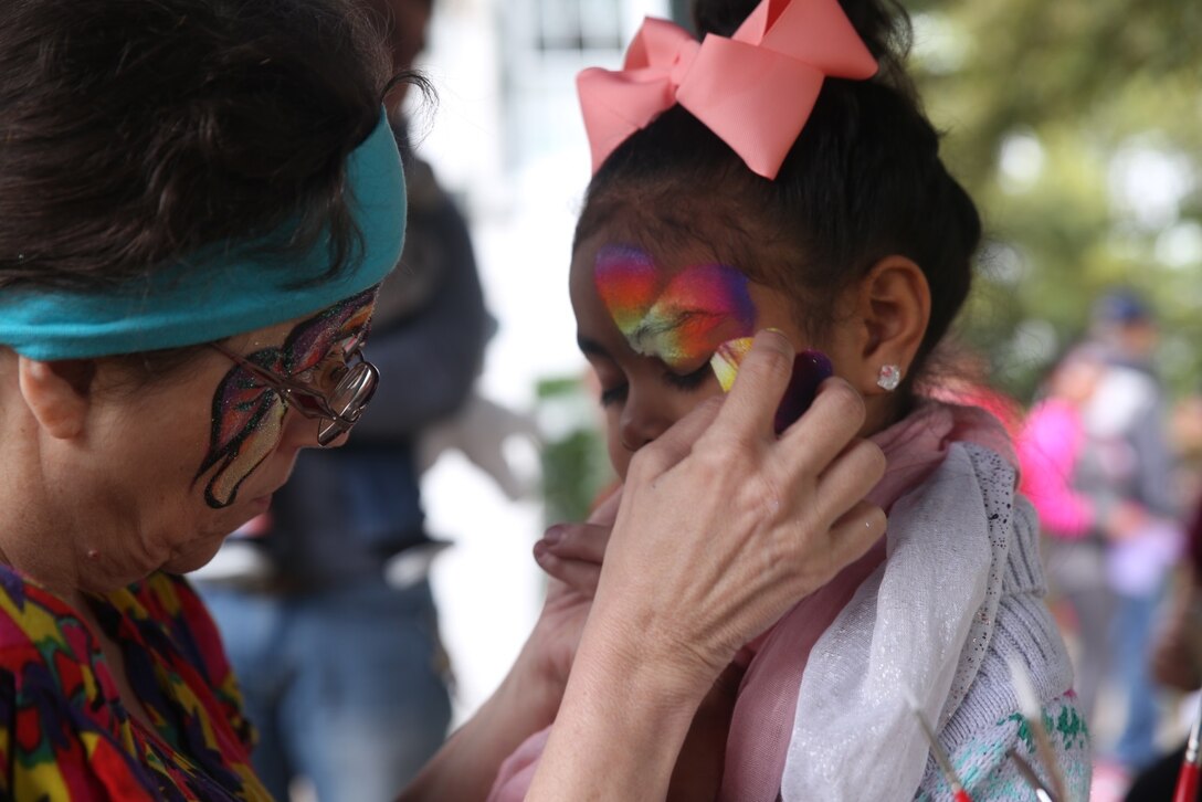 A young girl has her face painted at the home of Lt. Gen. Rex C. McMillian, commander of Marine Forces Reserve and Marine Forces North, during the Super-Sized Command Easter Egg Hunt, March 26, 2016. Uniformed service members assigned to MFR and MFN, their families and members of the greater Algiers community were invited to celebrate the holiday together at the historical house.