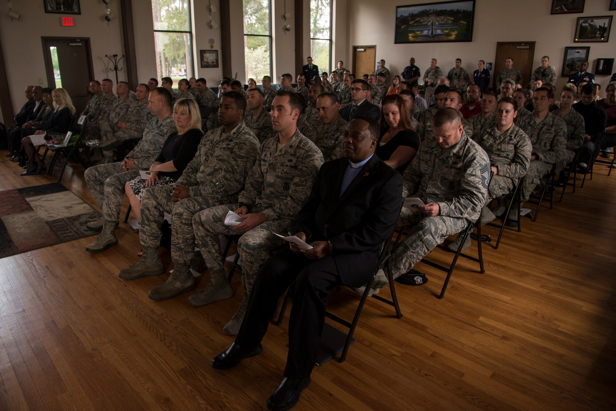 Family, friends, senior leadership and co-workers listen to officiating remarks during the retirement ceremony of U.S. Air Force Chief Master Sgt. Manuel Camacho, 23d Security Forces Squadron manager, March 28, 2016, at Moody Air Force Base, Ga. Attendees shared their support with Camacho’s family while celebrating his 30 years of service in the United States Air Force. (U.S. Air Force photo by Airman 1st Class Janiqua P. Robinson/Released)