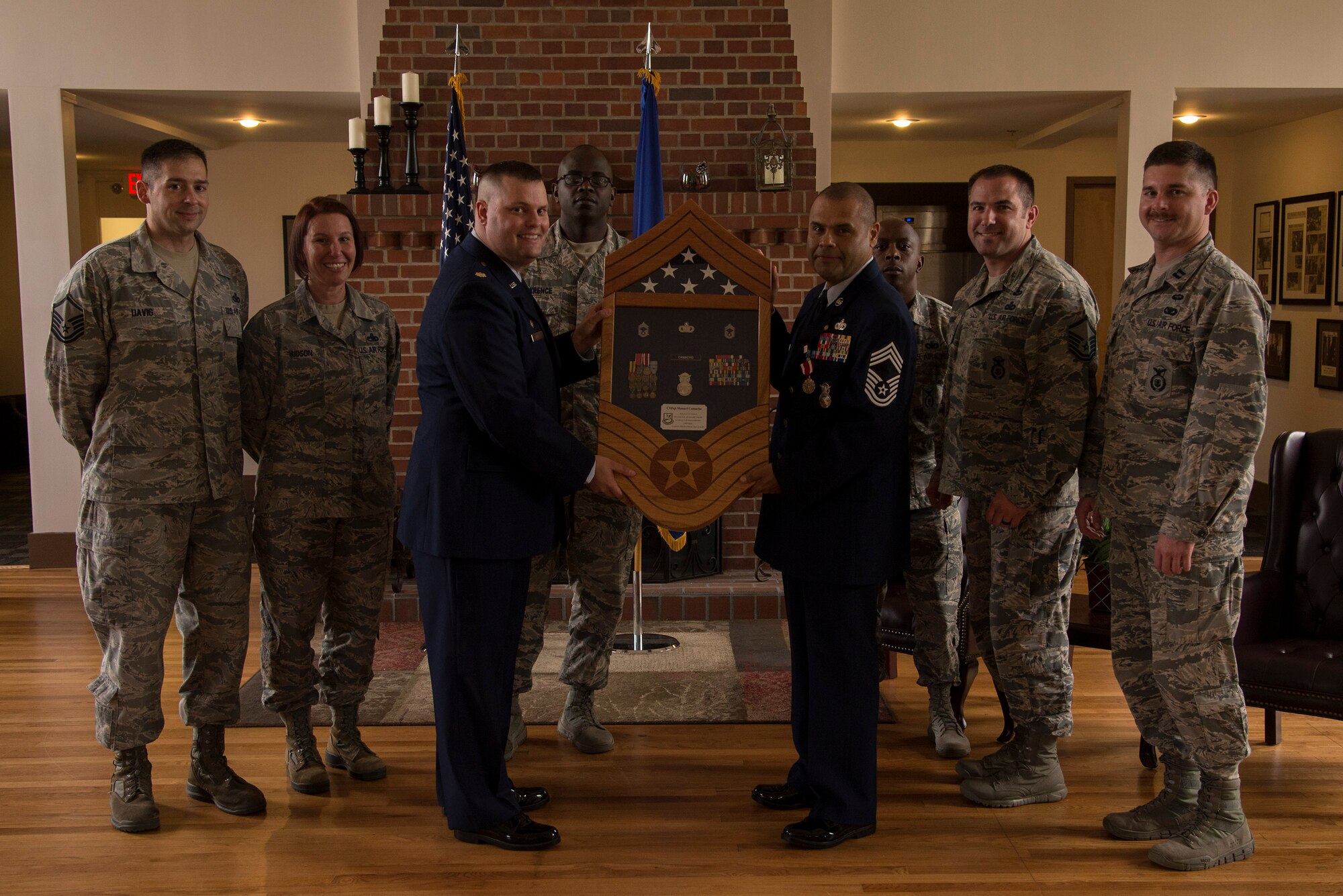 Members of the 23d Security Forces Squadron present U.S. Air Force Chief Master Sgt. Manuel Camacho, 23d SFS manager, with a shadow box during his retirement ceremony, March 28, 2016, at Moody Air Force Base, Ga. Camacho was responsible for ensuring combat readiness of approximately 50 Air Base Defense mobility teams, administering the Status of Resources and Training System reports and acted as an advisor to the commander on force protection and antiterrorism initiatives. (U.S. Air Force photo by Airman 1st Class Janiqua P. Robinson/Released)