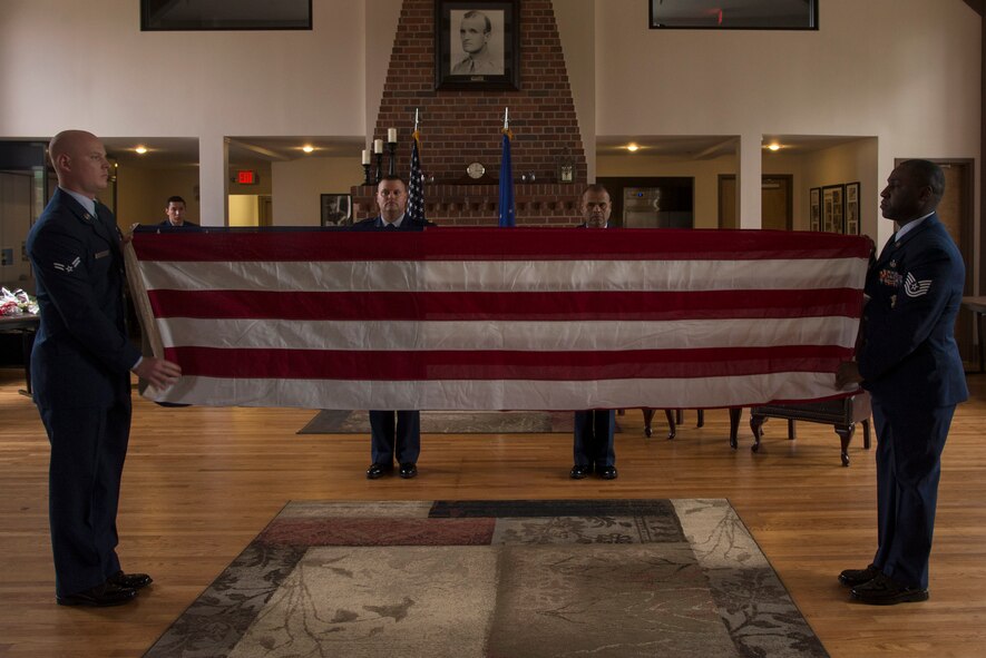 U.S. Air Force Airmen from Moody’s Base Honor Guard fold a flag during the retirement ceremony for U.S. Air Force Chief Master Sgt. Manuel Camacho, 23d Security Forces Squadron manager, March 28, 2016, at Moody Air Force Base, Ga. The flag was folded and presented to Camacho in honor of his 30 years of service. (U.S. Air Force photo by Airman 1st Class Janiqua P. Robinson/Released)