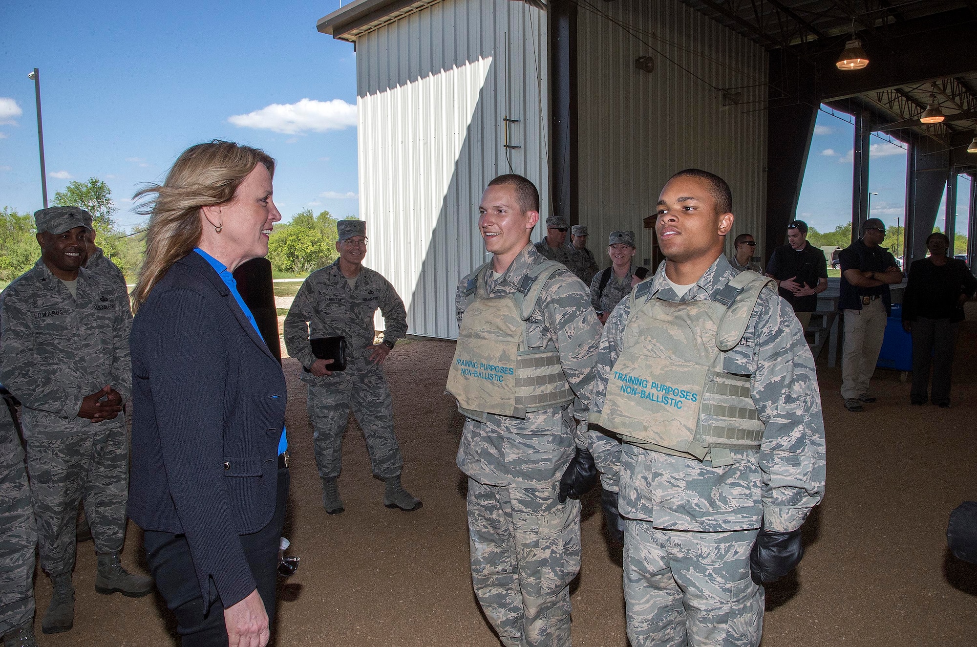 Secretary of the Air Force Deborah Lee James speaks with two basic trainees before a demonstration at the Basic Expeditionary Airmen Skills Training (BEAST) course March 22, 2016, at the 319th Training Squadron on Joint Base San Antonio-Lackland, Texas. James visited Lackland to view the Forward Operating Base of the Future, an Air Force initiative to increase energy efficiency at the BEAST site by converting one of the six zones into a completely solar powered area. James was given a tour of the BEAST complex, which hosts the Air Force basic military training's field week where a warrior ethos is instilled in trainees as they complete various combat and confidence building skills such as combatives, a leadership reaction course and courses on the U.S. Code of Conduct. (U.S. Air Force photo/Johnny Saldivar) 