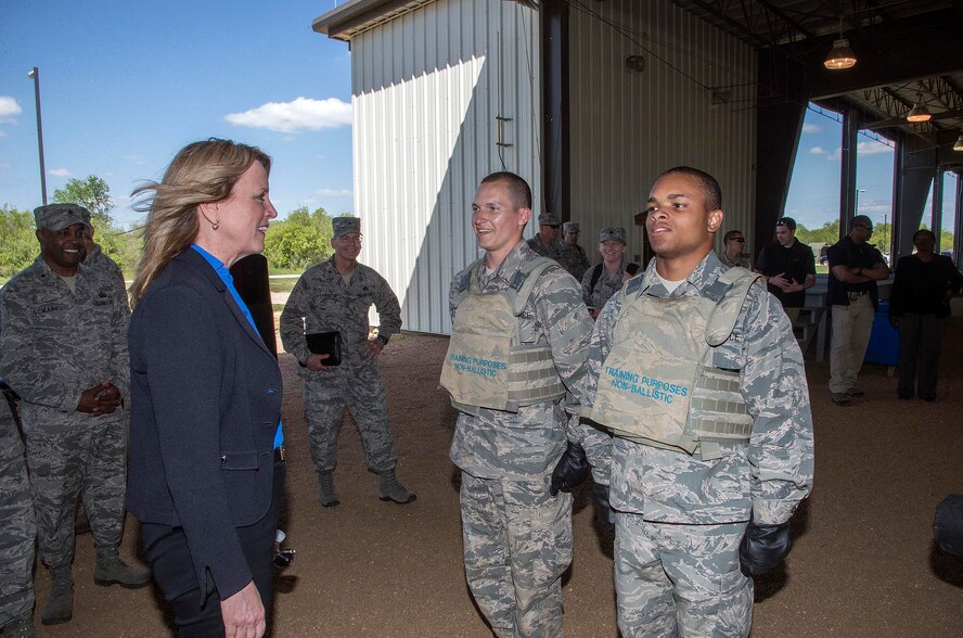 Air Force Secretary Deborah Lee James speaks with two basic trainees before a demonstration at the Basic Expeditionary Airmen Skills Training (BEAST) course March 22, 2016, at the 319th Training Squadron on Joint Base San Antonio-Lackland, Texas. James visited Lackland to view the Forward Operating Base of the Future, an Air Force initiative to increase energy efficiency at the BEAST site by converting one of the six zones into a completely solar powered area. (U.S. Air Force photo/Johnny Saldivar) 