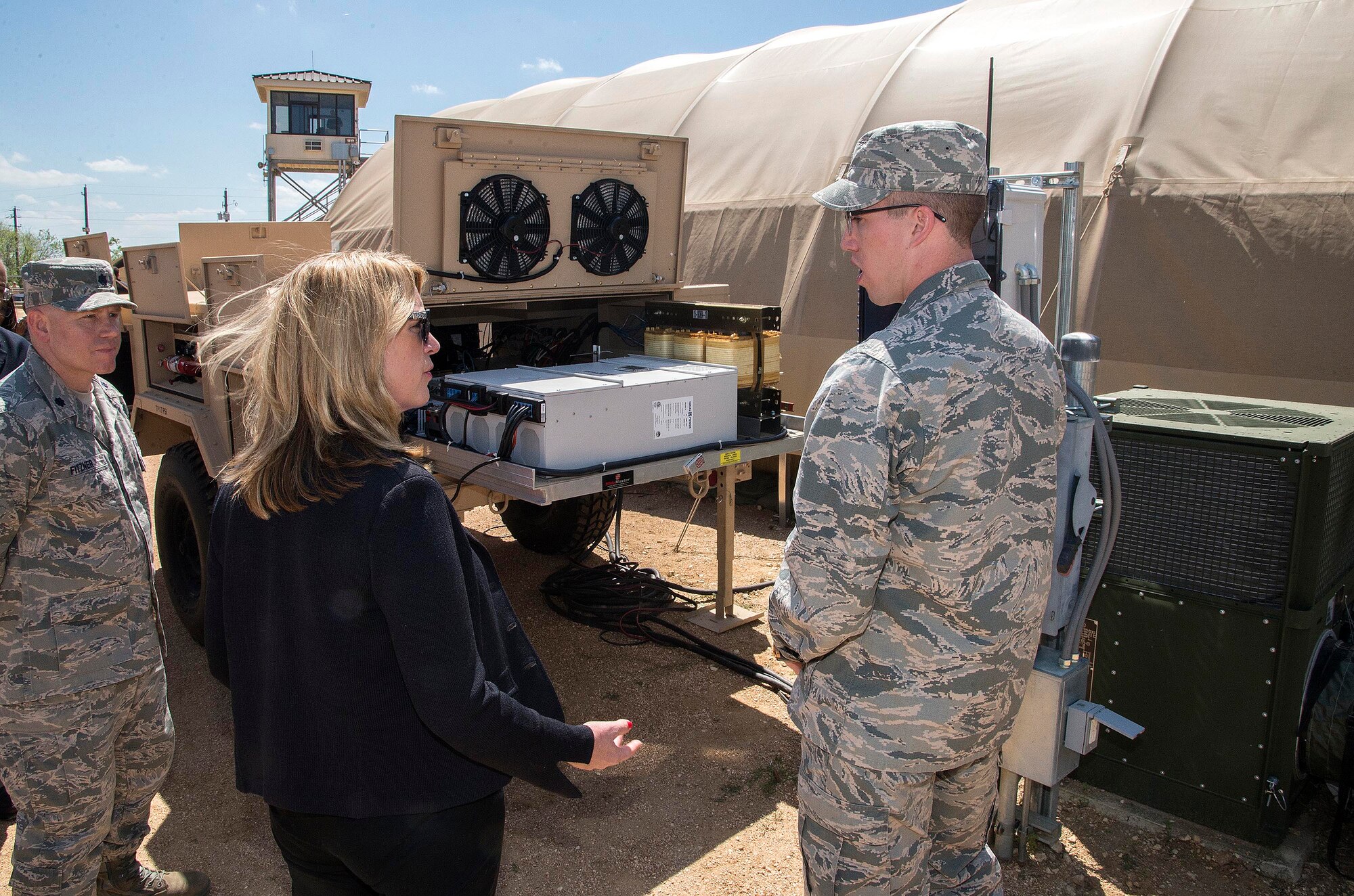 Secretary of the Air Force Deborah Lee James speaks with 1st Lt. Jonathan Goins,the  energy and environment research engineer with the Air Force Research Laboratory (AFRL), about the process of converting an area of the Basic Expeditionary Airmen Skills Training (BEAST) site to operate completely on solar power March 22, 2016, at the 319th Training Squadron on Joint Base San Antonio-Lackland, Texas. James visited the 37th Training Wing to learn about the Forward Operating Base (FOB) of the Future project, a joint venture between the AFRL and the University of Dayton Research Institute which converted one zone of the BEAST complex to generate onsite power from renewable energy. The data from this prototype will help guide remaining technology maturation efforts and potentially accelerates the modernization of FOBs throughout the Defense Department. (U.S. Air Force photo/Johnny Saldivar)