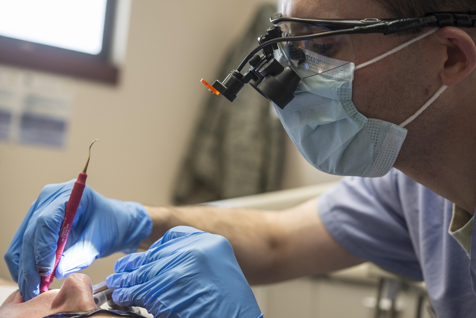 U.S. Air Force Capt. Jeffery Kohler, a 354th Medical Group general dentist, cleans around a new crown March 21, 2016, at Eielson Air Force Base, Alaska. The 354th MDG dental clinic recently received dental equipment that consists of a digital impression machine, a mill and an oven, which reduces a three-week, four-appointment process to a same day process completed in a few hours. (U.S. Air Force photo by Staff Sgt. Joshua Turner/Released)