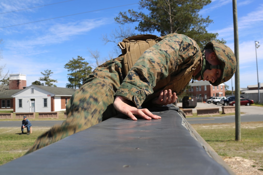 Sgt. Scott Maynard negotiates an obstacle during a team building exercise at Marine Corps Air Station Cherry Point, N.C., March 18, 2016. The obstacle course is utilized as a confidence builder for Marines as it challenges their physical and mental strength while encouraging leadership skills. Maynard is a food service specialist with Headquarters and Headquarters Squadron. (U.S. Marine Corps photo by Cpl. N.W. Huertas/Released)