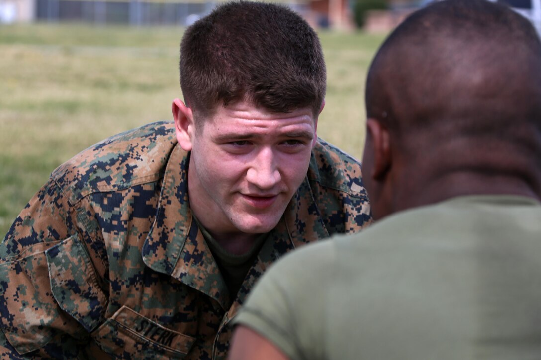 Cpl. Thomas Sterk participates in buddy push-ups during a team building exercise at Marine Corps Air Station Cherry Point, N.C., March 18, 2016. Marines participated in grappling matches after completing an obstacle course as it challenges their physical and mental strength while encouraging leadership skills. (U.S. Marine Corps photo by Cpl. N.W. Huertas /Released)