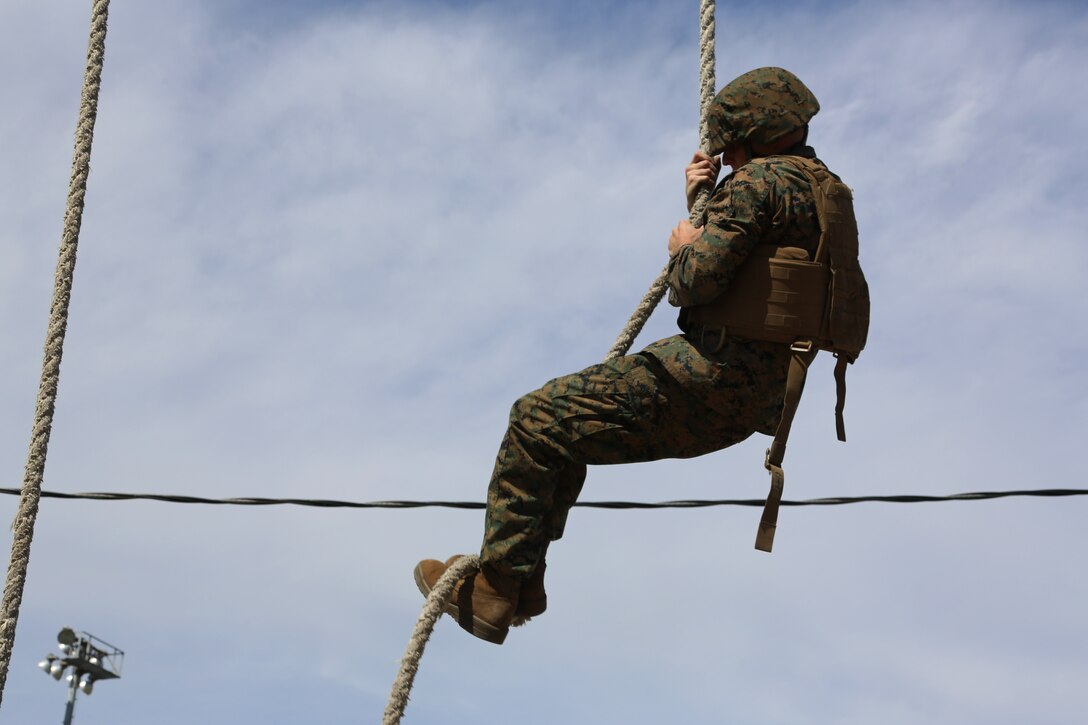 Sgt. Scott Maynard negotiates an obstacle during a team building exercise at Marine Corps Air Station Cherry Point, N.C., March 18, 2016. The obstacle course is utilized as a confidence builder for Marines as it challenges their physical and mental strength while encouraging leadership skills. Maynard is a food service specialist with Headquarters and Headquarters Squadron. (U.S. Marine Corps photo by Cpl. N.W. Huertas/Released)