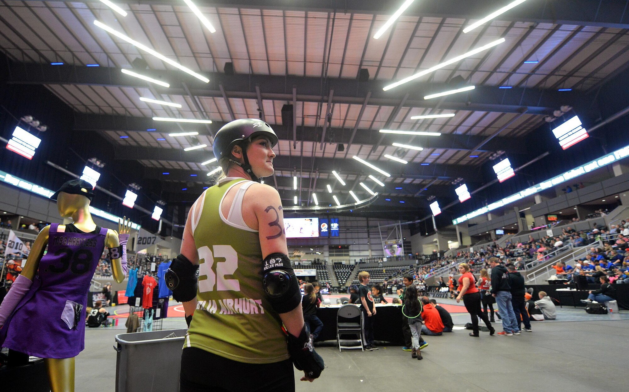 U.S. Air Force Maj. Jocelyn Smith, an executive officer with the 55th Wing Headquarters, looks over her shoulder at the scoreboard as the men’s roller derby games comes to an end at the Ralston Arena, Neb., March 26, 2016. Smith is an all-star roller derby member of the Omaha Rollergirls derby team.  (U.S. Air Force photo by Josh Plueger/Released)