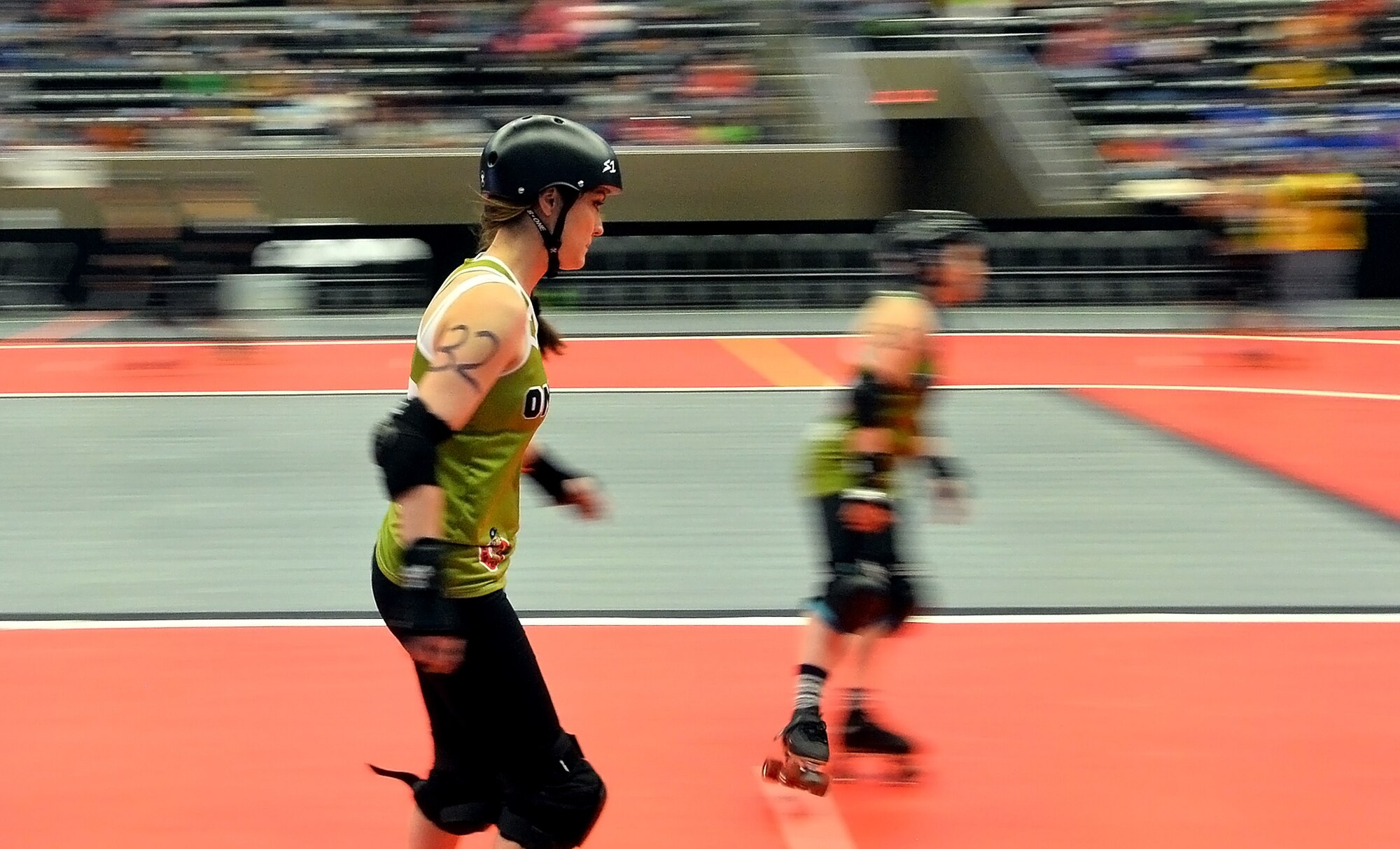 U.S. Air Force Maj. Jocelyn Smith, an executive officer with the 55th Wing Headquarters, skates a few warm up laps prior to the roller derby bout held at the Ralston Arena, Neb., March 26, 2016. Known as Amelia Airhurt, Smith is an All-Star roller derby member of the Omaha Rollergirls.  (U.S. Air Force photo by Josh Plueger/Released)