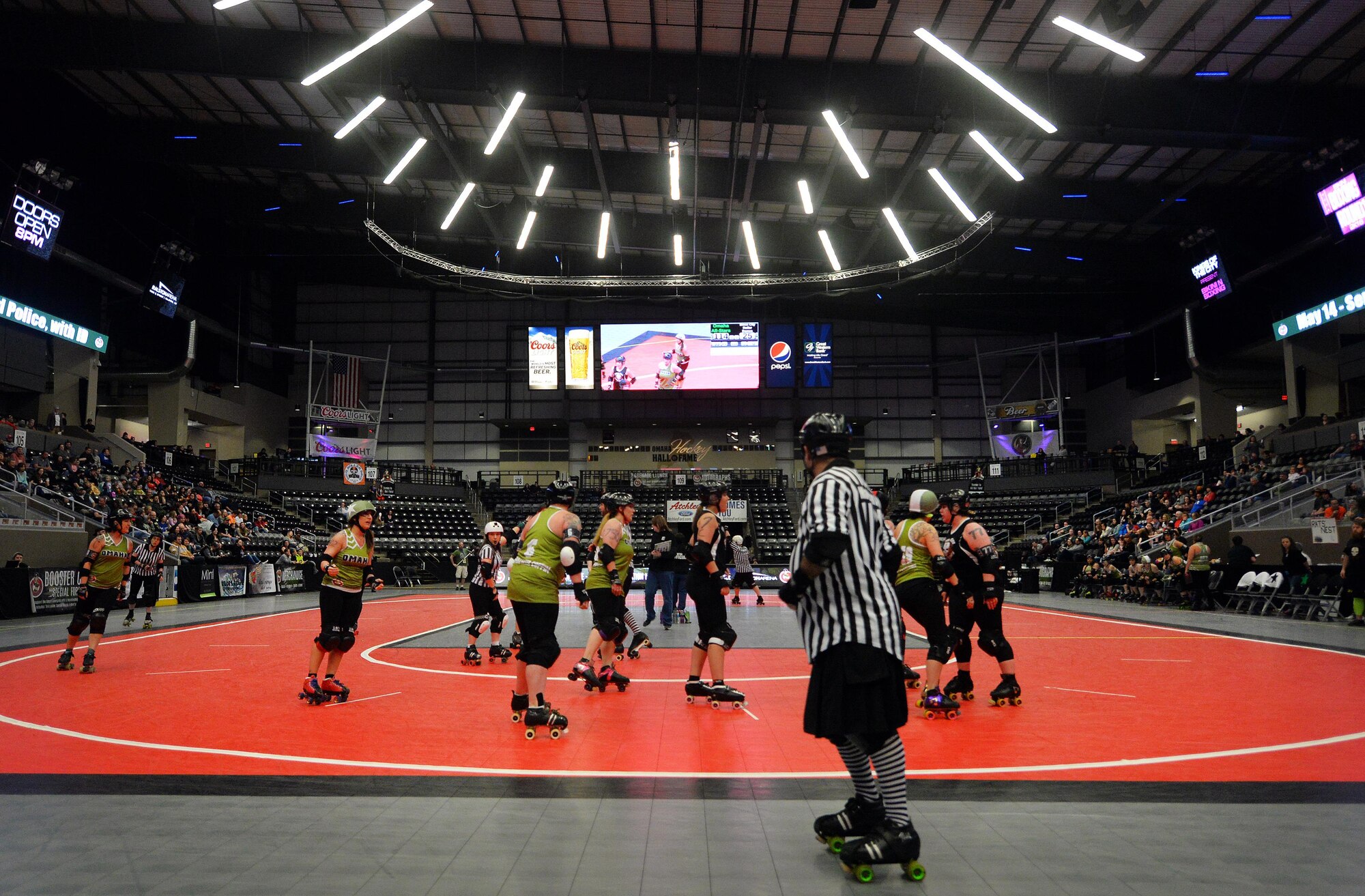 The Omaha Rollergirls take on the Sioux City Roller Dames in a bout held at the Ralston Arena, Neb., March 26, 2016. One of the All-Star jammers of the Rollergirls in an executive officer with the 55th Wing Headquarters known as Maj. Jocelyn Smith, but by night, Amelia Airhurt.  (U.S. Air Force photo by Josh Plueger/Released)