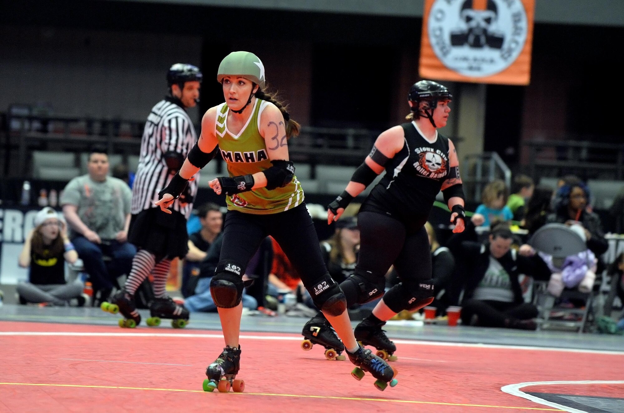 U.S. Air Force Maj. Jocelyn Smith, an executive officer with the 55th Wing Headquarters, skates past a blockade of Sioux City Roller Dames at the Ralston Arena, Neb., March 26, 2016. Smith, one a member of the Omaha Rollergirls, has been a participating in the roller derby sport for XX years.  (U.S. Air Force photo by Josh Plueger/Released) 