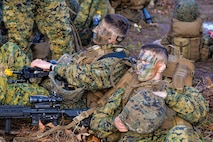 U.S. Marine Lance Cpls. Jacob Tucker and Shane Guillot riflemen with Bravo Company, 1st Battalion, 23rd Marine Regiment, 4th Marine Division, rest prior to beginning a patrol exercise at Barksdale Air Force Base, La., March 18, 2016. The Marines practiced proper equipment wear-techniques, weapon-carry postures and honed skills such as verbal and non-verbal communication and patrolling techniques. (U.S. Air Force photo/ Senior Airman Benjamin Raughton)