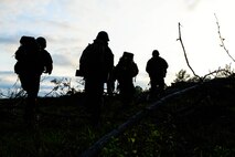 U.S. Marines with Bravo Company, 1st Battalion, 23rd Marine Regiment, 4th Marine Division, march up a hill in commencement of a two-day patrol exercise at Barksdale Air Force Base, La., March 18, 2016. Marines patrol in terrain such as wide open areas to highly-vegetated zones using tactical formations created to decrease visibility and reduce possible detection. (U.S. Air Force photo/ Senior Airman Benjamin Raughton)