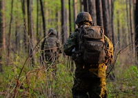 U.S. Marine Lance Cpl. Donovan Ginn, a Rifleman with Bravo Company, 1st Battalion, 23rd Marine Regiment, 4th Marine Division, patrols a wooded area during a training exercise at Barksdale Air Force Base, La., March 18, 2016. During the patrol, Marines honed techniques such as land navigation, low noise patrols and tactical squad movements. (U.S. Air Force photo/ Senior Airman Benjamin Raughton)