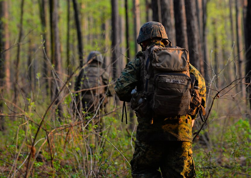 U.S. Marine Lance Cpl. Donovan Ginn, a Rifleman with Bravo Company, 1st Battalion, 23rd Marine Regiment, 4th Marine Division, patrols a wooded area during a training exercise at Barksdale Air Force Base, La., March 18, 2016. During the patrol, Marines honed techniques such as land navigation, low noise patrols and tactical squad movements. (U.S. Air Force photo/ Senior Airman Benjamin Raughton)