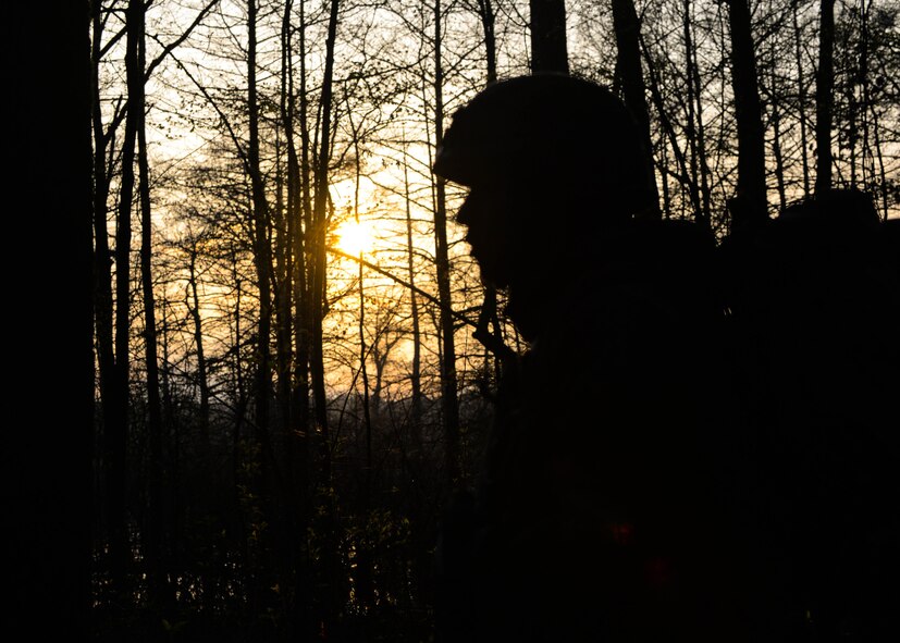 A U.S. Marine with Bravo Company, 1st Battalion, 23rd Marine Regiment, 4th Marine Division, patrols a wooded area during a training exercise at Barksdale Air Force Base, La., March 18, 2016. The exercise took two days and allowed the Marines to conduct defensive and offensive maneuvers in day time and night time conditions. (U.S. Air Force photo/ Senior Airman Benjamin Raughton)