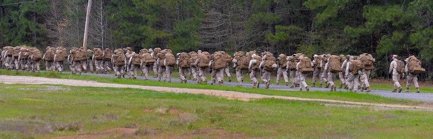 U.S. Marines with Bravo Company, 1st Battalion, 23rd Marine Regiment, 4th Marine Division, carry equipment to a staging site during a patrol exercise at Barksdale Air Force Base, La., March 18, 2016. The Marines carried rucksacks with over 70 pounds of equipment to and from the exercise site. The rucksacks included sleeping bags, rain gear, food and other items. (U.S. Air Force photo/Senior Airman Mozer O. Da Cunha)