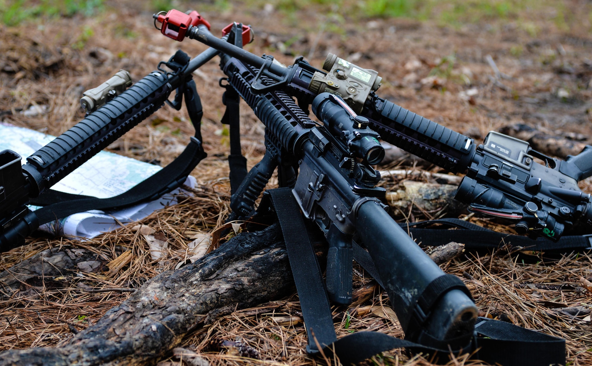 M16 rifles are stacked together during a training exercise at Barksdale Air Force Base, La., March 18, 2016. The M16 is the primary rifle used by The U.S. Marine Corps during basic training. Recruits must complete a fire course consisting of shooting targets that are 200, 300 and 500 yards away from the prone, sitting, kneeling and standing positions. Additionally, the Marine Corps is the only branch that has recruits shooting from distances as far as 500 yards away. (U.S. Air Force photo/Senior Airman Mozer O. Da Cunha)