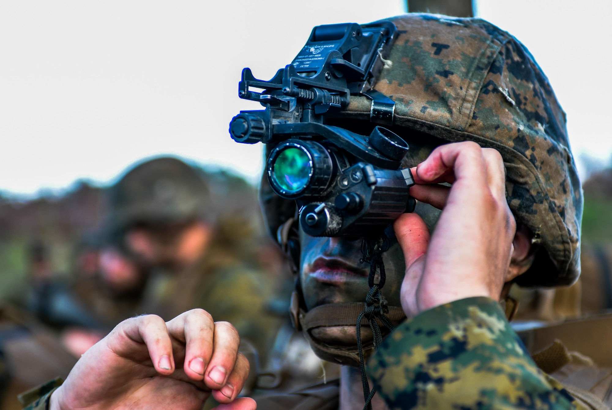 A U.S. Marine with Bravo Company, 1st Battalion, 23rd Marine Regiment, 4th Marine Division, adjusts a monocular night vision device in preparation for a patrol exercise at Barksdale Air Force Base, La., March 18, 2016. The night vision device was used to provide the user with enhanced visibility, facilitating detection of simulated threats during night time operations. (U.S. Air Force photo/Senior Airman Mozer O. Da Cunha)