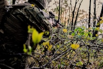 A U.S. Marine with Bravo Company, 1st Battalion, 23rd Marine Regiment, 4th Marine Division, takes cover during a patrol exercise at Barksdale Air Force Base, La., March 18, 2016. The exercise provided Marines with various opportunities to hone security post techniques. Additionally, the Marines worked as a team and created overlapping coverage overseeing individual fire sectors. (U.S. Air Force photo/Senior Airman Mozer O. Da Cunha)