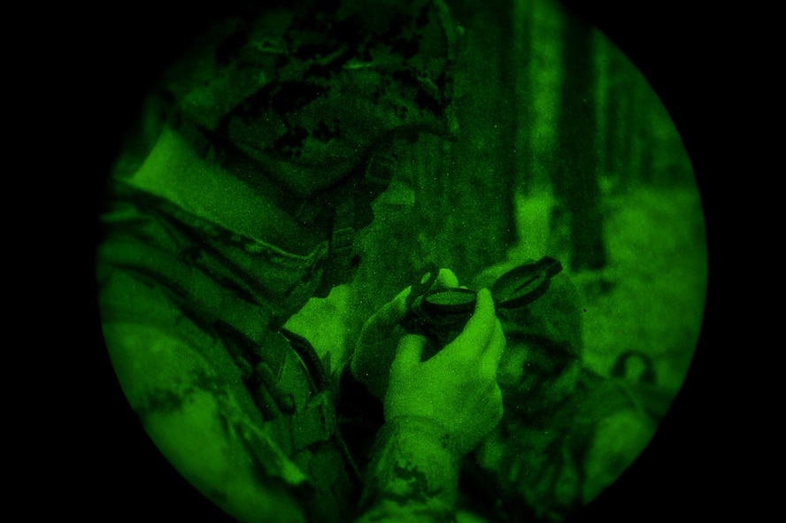 A U.S. Marine with Bravo Company, 1st Battalion, 23rd Marine Regiment, 4th Marine Division, checks a compass during a nighttime patrol exercise at Barksdale Air Force Base, La., March 18, 2016. The exercise site was divided into three different sections providing each of the participating platoons with an operations grid, giving participants the opportunity to hone land navigation skills. (U.S. Air Force photo/Senior Airman Mozer O. Da Cunha)