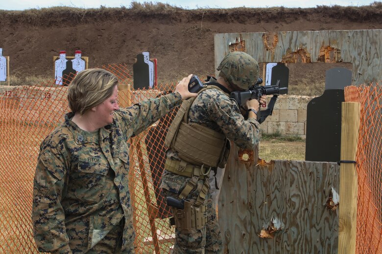 MARINE CORPS BASE HAWAII —  Gunnery Sgt. Tanya Fitch, a small arms instructor with Headquarters Battalion, times Lance Cpl. Drew Dodd, a rifleman with Fox Company, 2nd Battalion, 3rd Marine Regiment, during  the Pacific Combat Shooting Match at the Kaneohe Bay Range Training Facility aboard Marine Corps Base Hawaii, March 16, 2016. Teams from different units used various weapons and tactics to achieve the fastest time possible on different courses of fire, while earning points for awards during the competition. Marines from the Marine Corps Combat Shooting Team instructed and gave advice to the Marines participating in the event. (U.S. Marine Corps Photo by Lance Cpl. Jesus Sepulveda Torres)