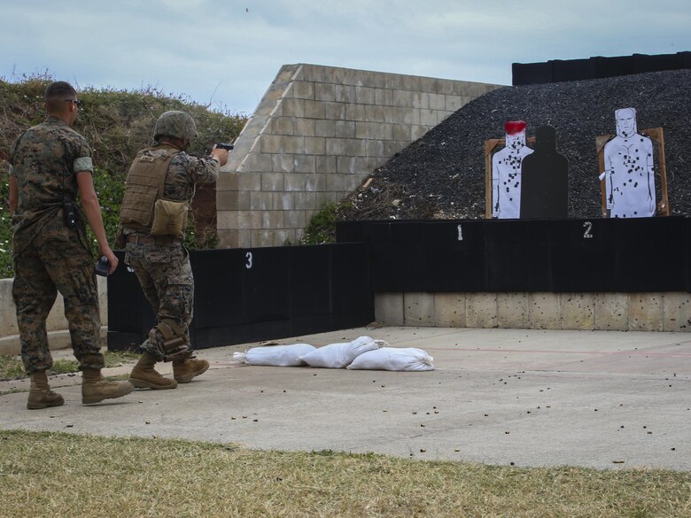 MARINE CORPS BASE HAWAII — Cpl. Zachary Summers, a radio operator with 3rd Radio Battalion, combat glides toward a target shooting his M9 Service Pistol during a Pacific Combat Shooting Match at the Kaneohe Bay Range Training Facility aboard Marine Corps Base Hawaii, March 16, 2016. Teams from different units used various weapons and tactics to achieve the fastest time possible on different courses of fire, while earning points for awards during the competition. Marines from the Marine Corps Combat Shooting Team instructed and gave advice to the Marines participating in the event. (U.S. Marine Corps Photo by Lance Cpl. Jesus Sepulveda Torres)