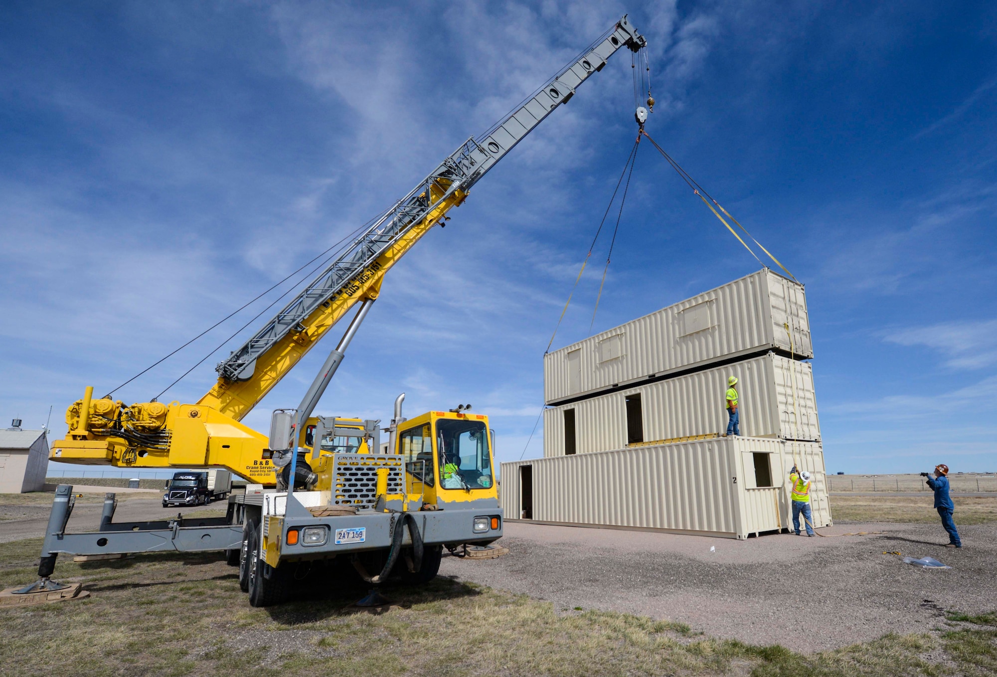 Independent contractors use a crane to place a conex building during the construction of the Military Operations Urban Terrain training area at Ellsworth Air Force Base, S.D., March 21, 2016. The training facility will be used bi-weekly by the 28th Security Forces Squadron to cover active shooters, work place violence, combat readiness tasks and shoot-move-communicate exercises. (U.S. Air Force photo by Airman 1st Class Sadie Colbert/Released)