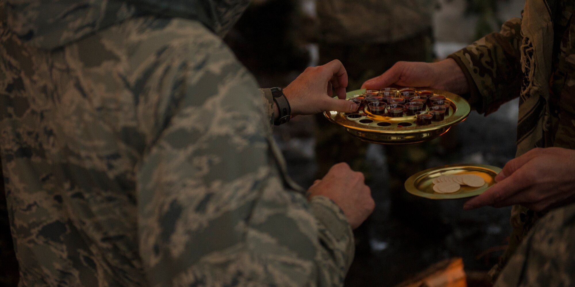 Chaplain(Capt.) Joshua Rumsey, 336th Training Group chaplain , provides communion to Airmen in the field March 27, 2016, at Fairchild Air Force Base, Wash. Rumsey would like to see the program expand to meet as many religious needs as possible regardless of faith. (U.S. Air Force photo/Airman 1st Class Sean Campbell)