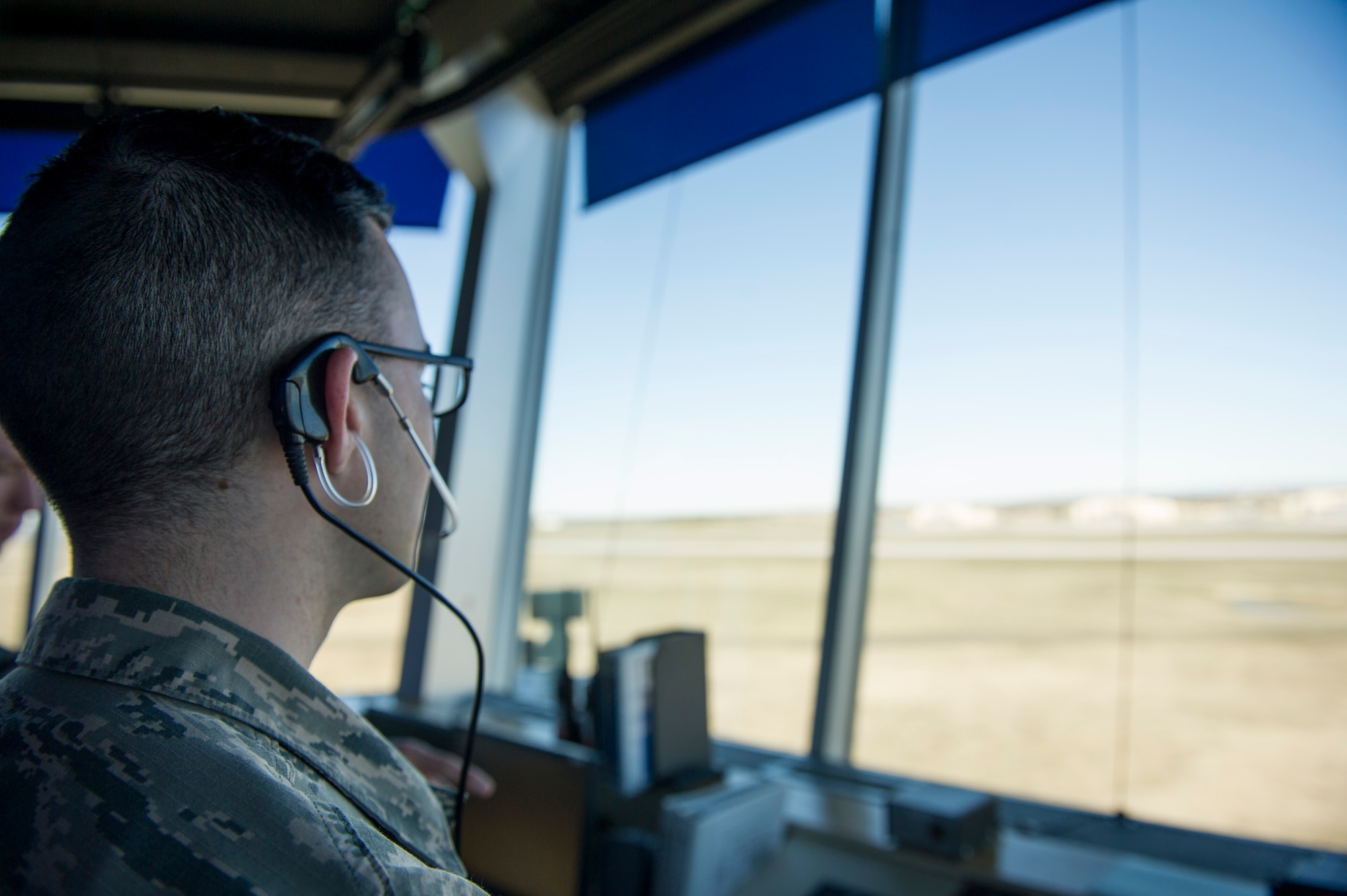 Airman 1st Class Parker Ricker, 92nd Operation Support Squadron air traffic control apprentice, looks out over the flight line while completing his daily duties March 18, 2016, at Fairchild Air Force Base, Wash. Spokane International Airport owns all of the airspace surrounding Fairchild. For inbound or outbound military aircraft that require use of the airspace, GEG will transfer control of the area that Fairchild operates in. (U.S. Air Force photo/Airman 1st Class Sean Campbell)