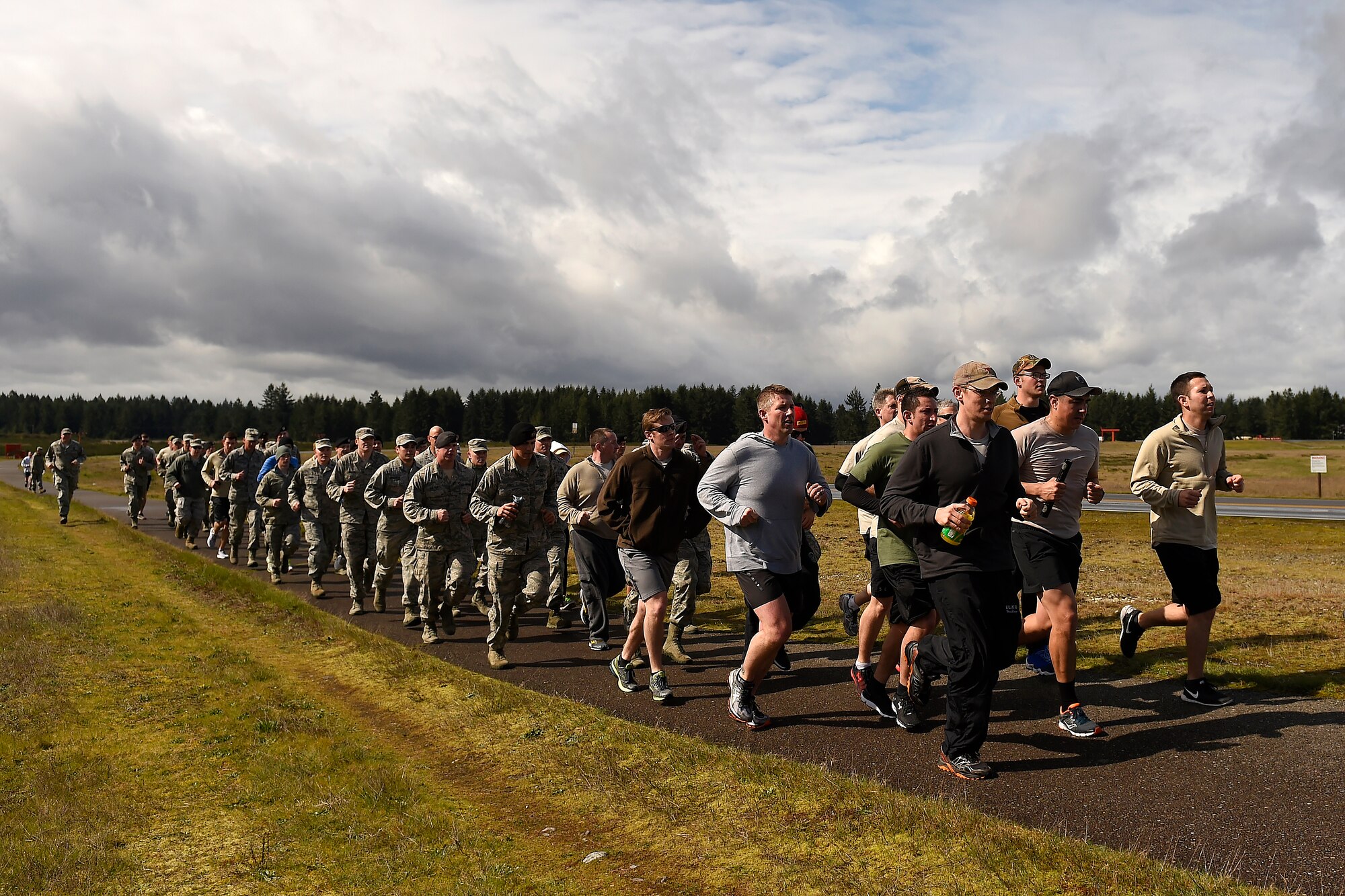 Runners in the Tactical Air Control Party 24-hour-run, finish the last run of the event together at Joint Base Lewis-McChord, Wash., March 24, 2016. JBLM runners logged more than 911 and raised $5,879 for the TACP Association. (U.S. Air Force photo/Tech. Sgt. Tim Chacon)