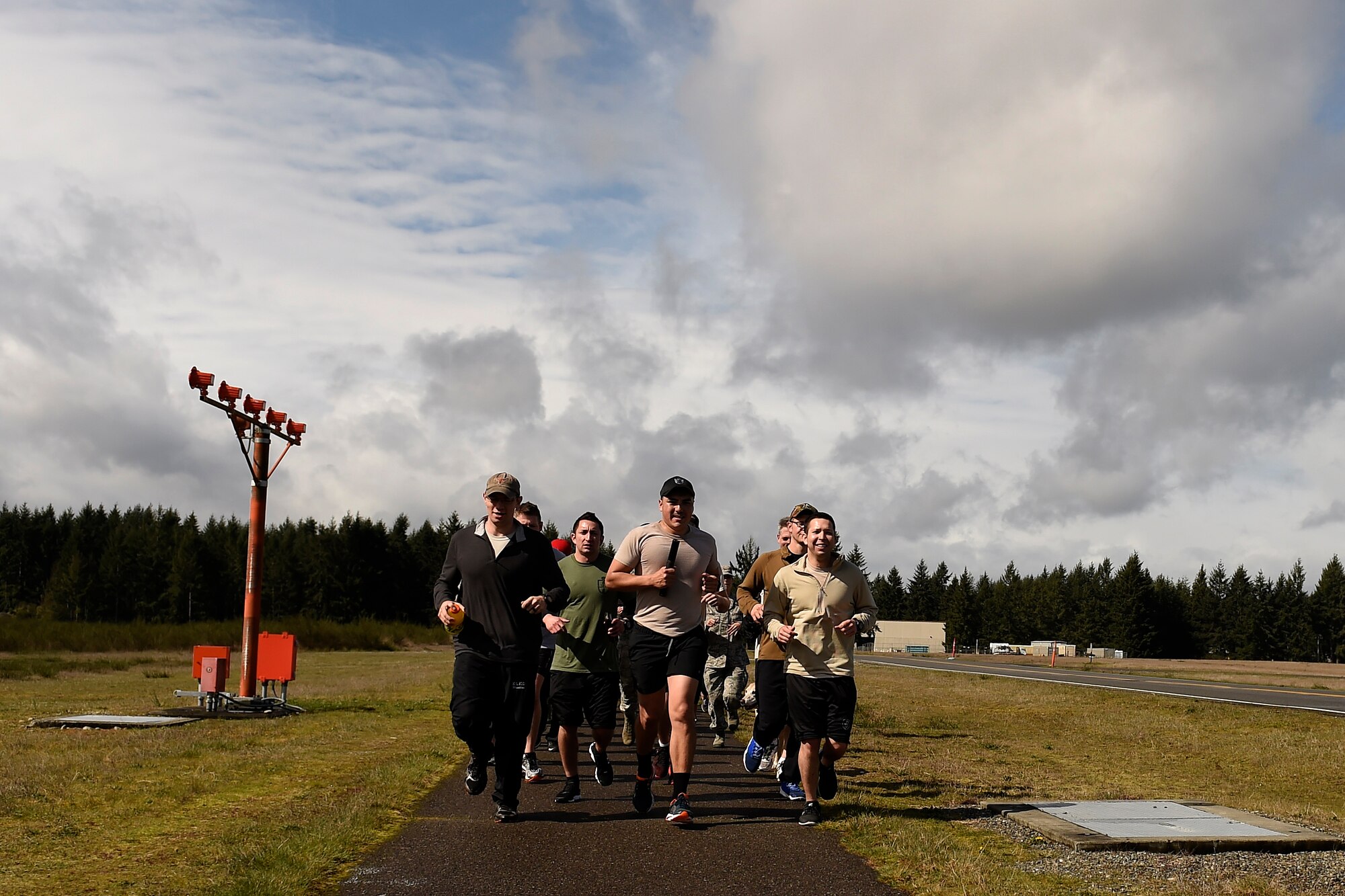 Runners in the Tactical Air Control Party 24-hour-run, finish the last run of the event together at Joint Base Lewis-McChord, Wash., March, 24, 2016. The run is done by TACP units all over the world at the same time to raise money for and honor fallen TACPs. (U.S. Air Force photo/Tech. Sgt. Tim Chacon)