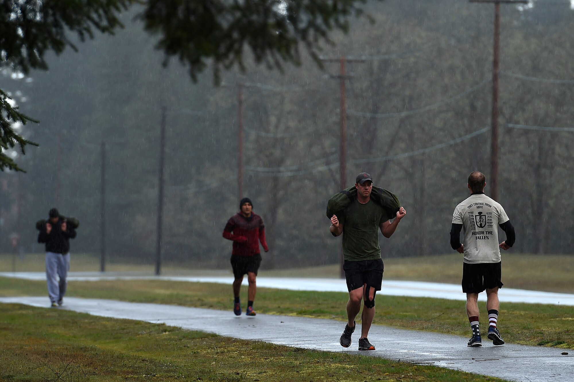 Runners in the Tactical Air Control Party 24-hour-run, do not let the elements deter them from running at Joint Base Lewis-McChord, Wash., March, 24, 2016. Participants in the run could run in teams or as induvials in an effort to log as many miles as possible to help raise money for the TACP Association. (U.S. Air Force photo/Tech. Sgt. Tim Chacon)