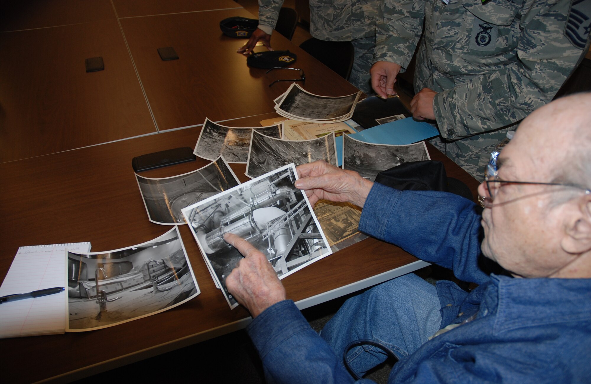 CHEYENNE MOUNTAIN AIR FORCE STATION, Colo. – Bill Bunker, who served as an Air Force Policeman at Cheyenne Mountain Air Force Station when it went operational in 1966, shows off photos from his time stationed at CMAFS during recent visit to The Mountain. Bunker served two stints at the station and had not been back since his retirement almost 40 years ago. (U.S. Air Force photo by Dave Smith)