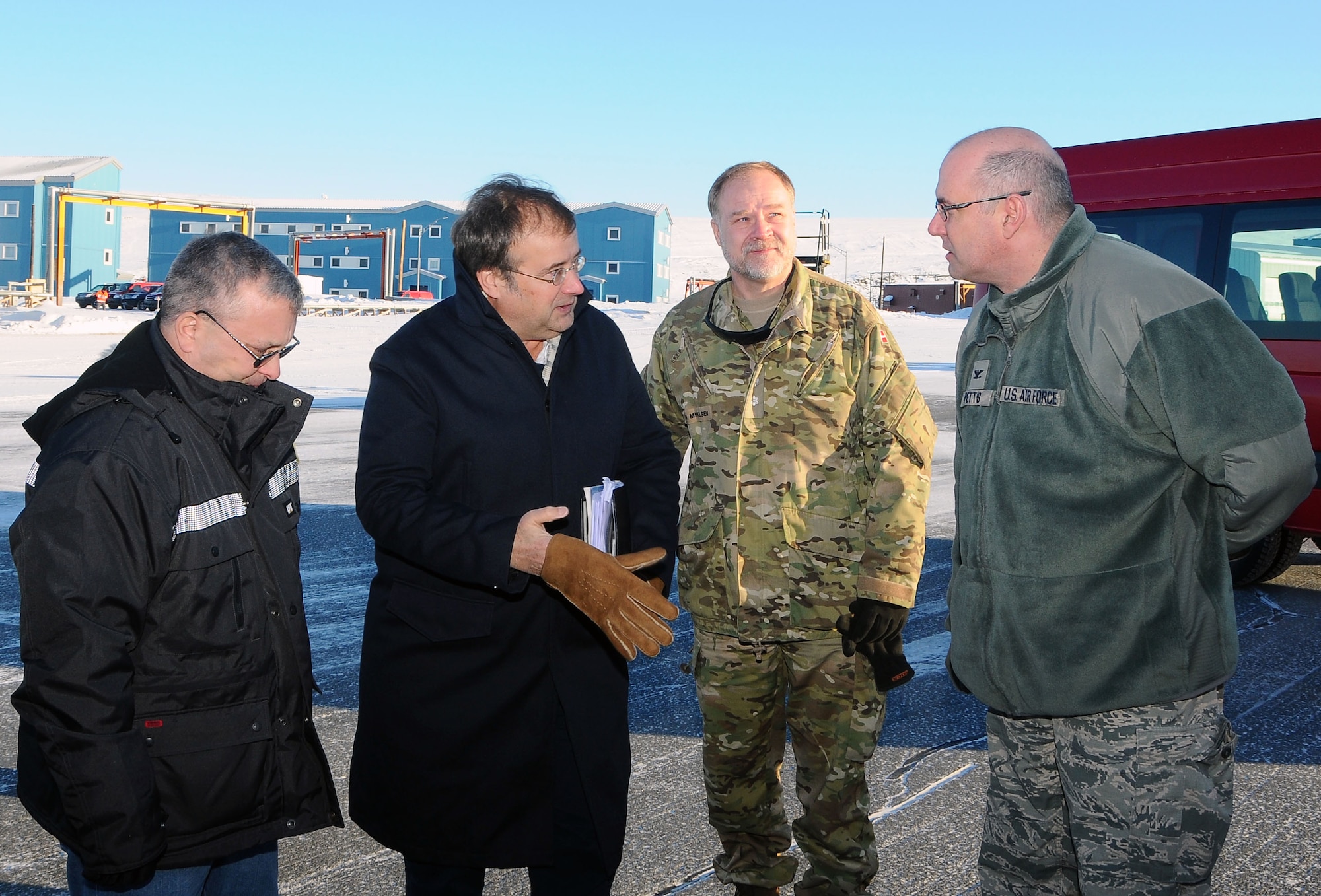 THULE AIR BASE, Greenland - Col. Stuart Pettis, 821st Air Base Group commander (right) greets members of the Danish parliament and U.S. Embassy during a visit to Thule Air Base, Greenland on March 23, 2016. While there, the team visited the air traffic control tower and received a mission brief. (courtesy photo)