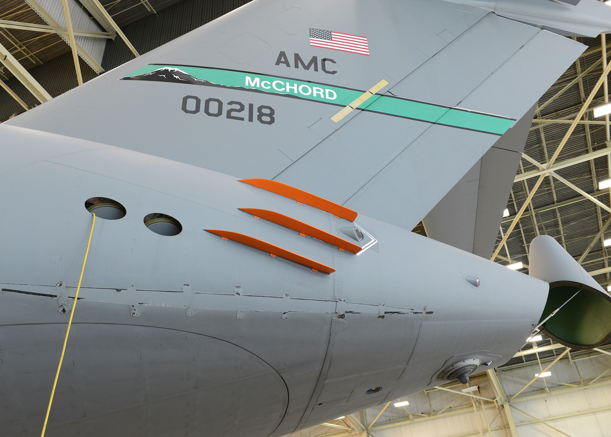 The first phase of C-17 Drag Reduction testing consisted of putting six orange finlets on the aft part of the fuselage. A C-17 on loan from Joint Base McChord-Lewis, Washington, is the test plane for the program. With three finlets on each side, test sorties were conducted to see how the C-17 performed with the modification. (U.S. Air Force photo by Kenji Thuloweit) 