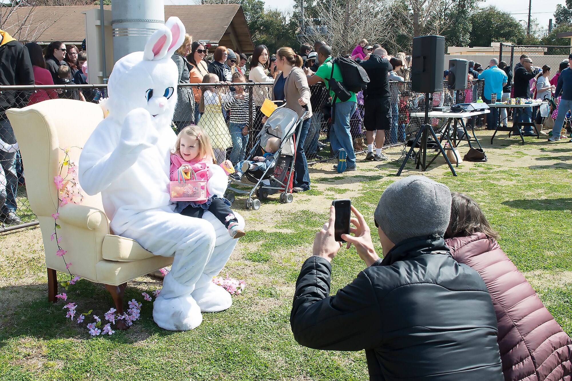 Team Yokota members take pictures of their children with the Easter Bunny at Yokota Air Base, Japan, March 26, 2016. The event included an egg hunt, bouncy castles and an Easter Bunny mascot. (U.S. Air Force photo by Senior Airman David C. Danford/Released)