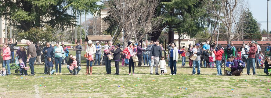 Parents with children line up to participate in the Annual Easter Egg Hunt at Yokota Air Base, Japan, March 26, 2016. The event was divided by age group, allowing a more fair chance for children to gather candy and Easter eggs. (U.S. Air Force photo by Senior Airman David C. Danford/Released)