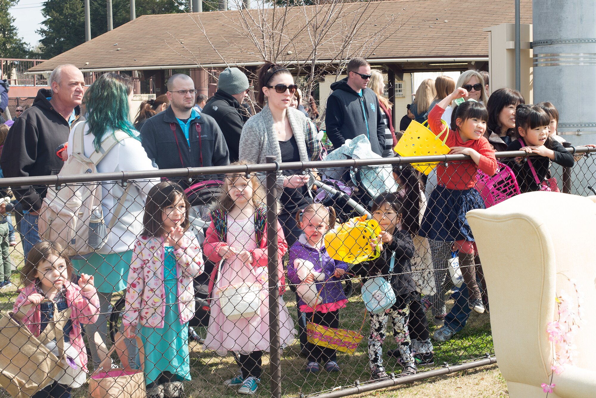 Families gather to participate in the Annual Easter Egg Hunt at Yokota Air Base, Japan, March 26, 2016. The event was divided by age group, allowing a more fair chance for children to gather candy and Easter eggs. (U.S. Air Force photo by Senior Airman David C. Danford/Released)