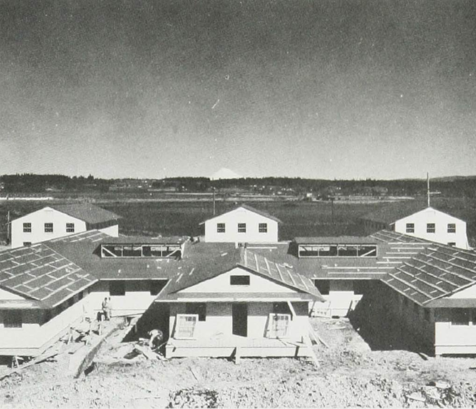 Construction is seen underway in the cantonment area of Portland Army Air Base in 1941.  Note snow-capped Mount Saint Helens in her former glory in the distance.  (Courtesy Portland District, Army Corps of Engineers)
