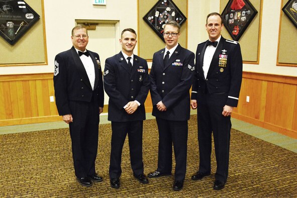 120th Airlift Wing Commander Col. Lee Smith (right) and the 120th Airlift Wing Command Chief, Chief Master Sgt. Steven Lynch (left), stand with the wing’s newest Airman Leadership School graduates (center left to right), Senior Airman Nicholaus Schwall and Senior Airman Nikolas Asmussen, following their graduation ceremony held at Malmstrom Air Force Base, Mont., March 22, 2016. (U.S. Air National Guard photo by Senior Master Sgt. Eric Peterson)